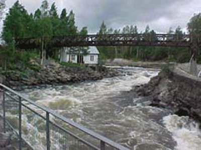 The old bridge in Fllfors and salmon stairs. A local fisherman landing salmon