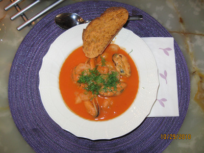 Pot soup with shrimp and mussels cooked with root vegetables