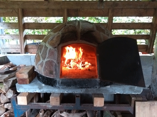 The pizza oven is heated to bake pizza for our lunch when we smoke eel