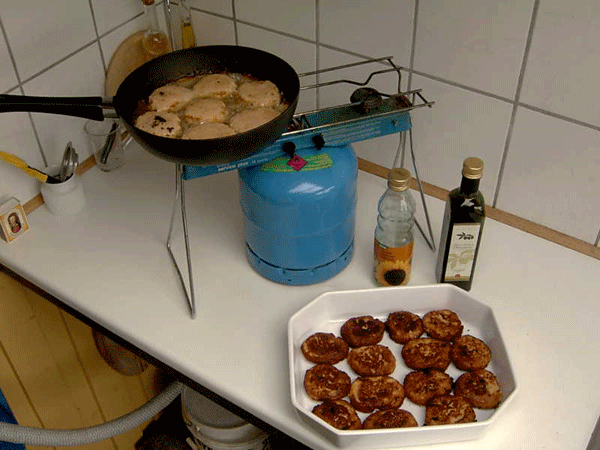 I fry the first sample of Thai Salmon Meatballs in my outdoor kitchen