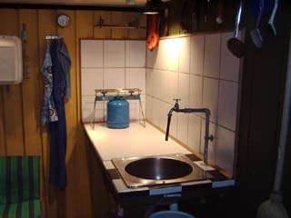 Outdoor kitchen with tiles over the table 
Outdoor-kitchen is now with sliding door