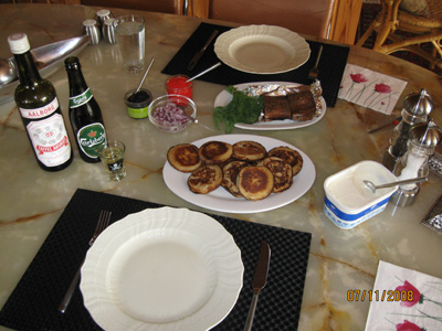 Russian pancakes with caviar and hot smoked trout